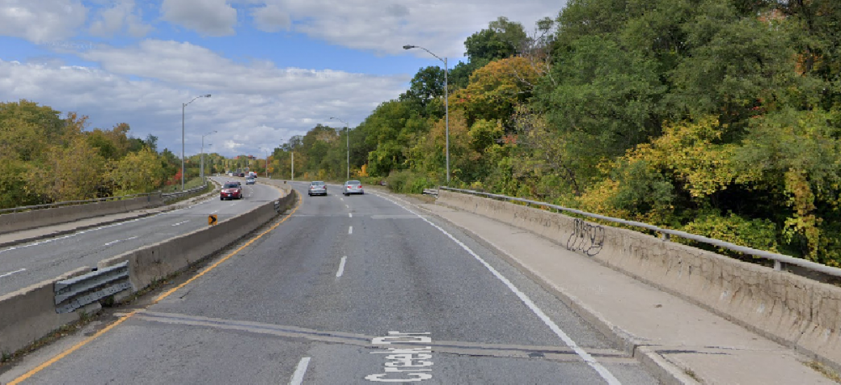 Wide street winds between trees