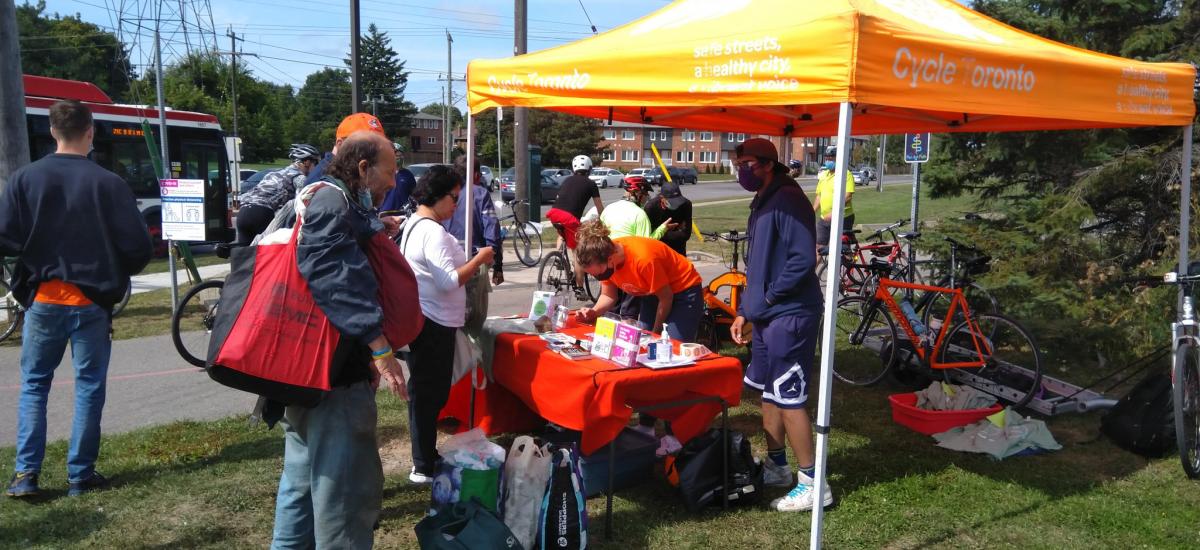 People queue up at a Cycle Toronto tent