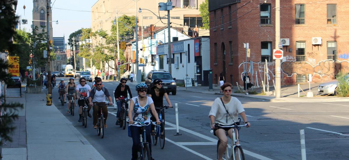 people riding on Adelaide St.