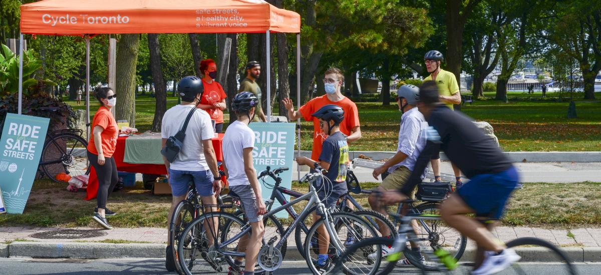 Youth on bikes queue up at a Cycle Toronto tent