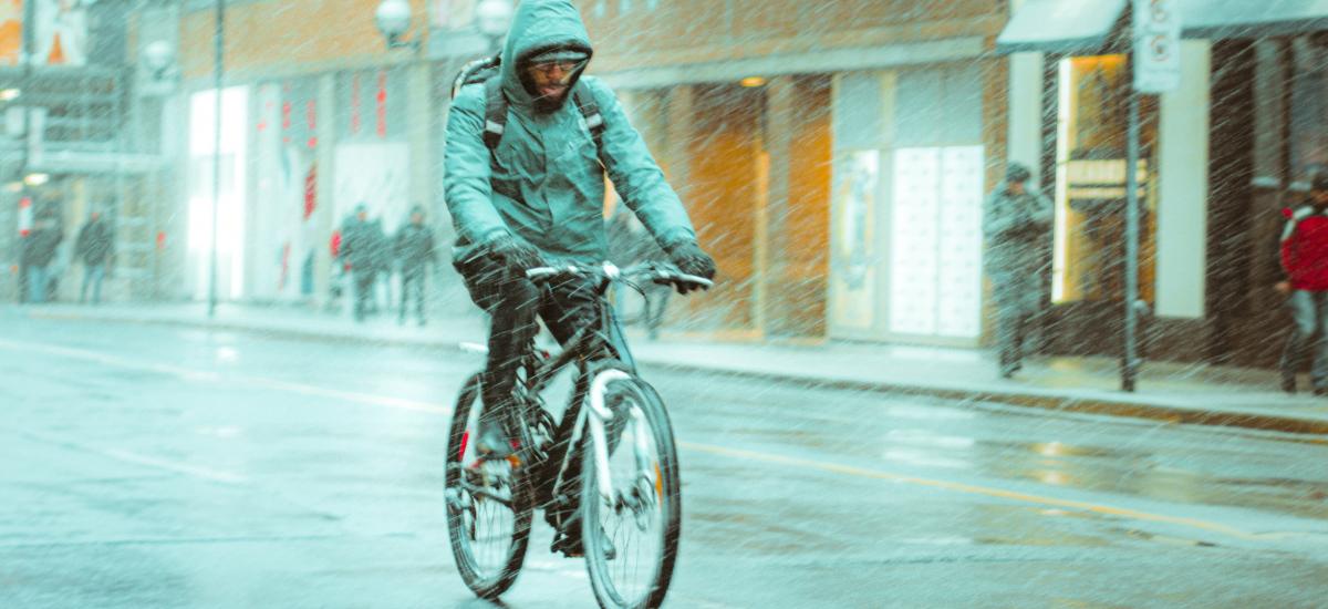 Person rides a bike in the rain.