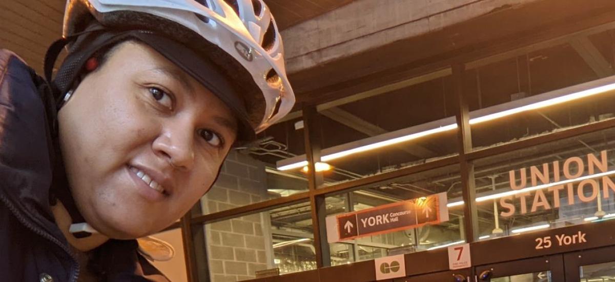 Taneisha wears a bike helmet outside Union Station