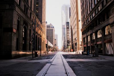 Empty street stretches off into the distance between skyscrapers