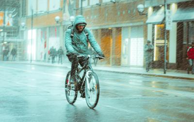 Person rides a bike in the rain.