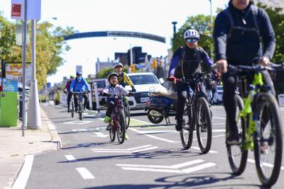 People ride bikes in a bike lane