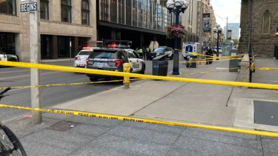 Police tape and vehicles line an intersection