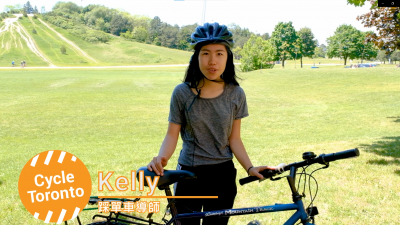 Person standing with a bike in a field