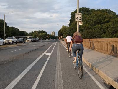 People ride bikes in a buffered bike lane