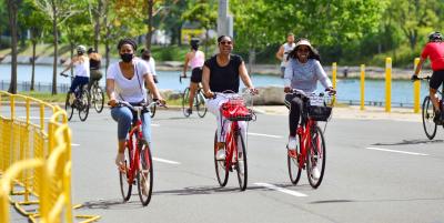 People ride rented bikes and Lake Shore