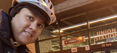 Taneisha wears a bike helmet outside Union Station