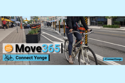 Person riding their bike down Yonge Street protected bike lanes