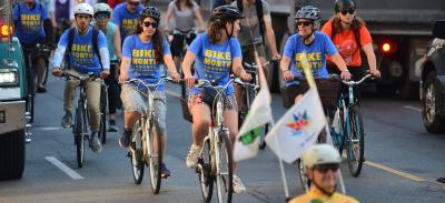 group riding on yonge street with blue Bike Month tshirts