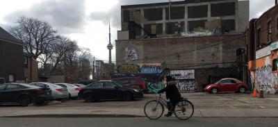 Michaela pedalling along Cecil Street with the CN Tower in the background