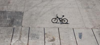 one lonely bike parked in parking lot