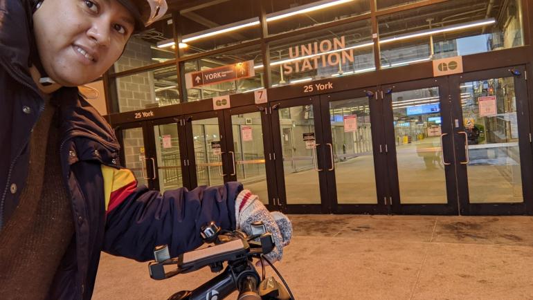 Taneisha wears a bike helmet outside Union Station