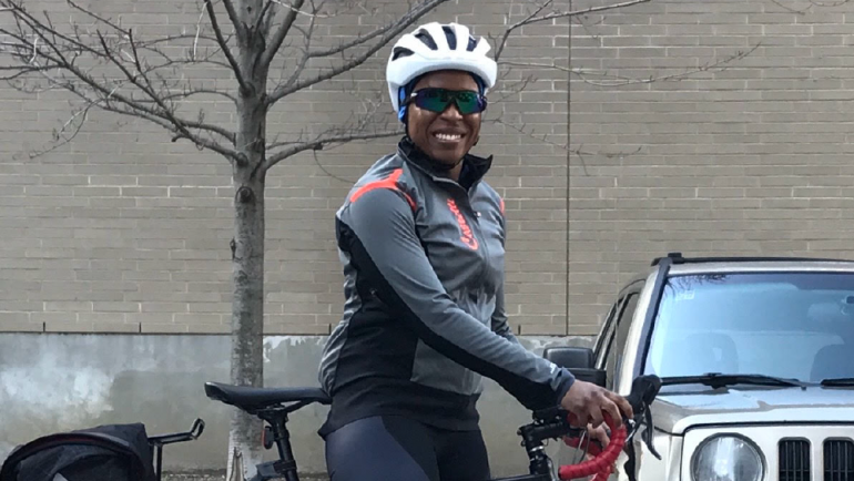 Smiling woman wearing a bike helmet