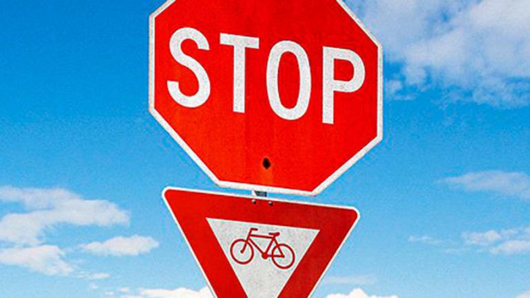 A stop sign for motor vehicles and a yield sign for bicycles