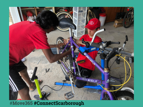 Two youths fixing their bike