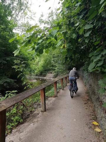 A person rides their bicycle on West Dean Trail