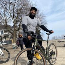 A man poses with his bike.