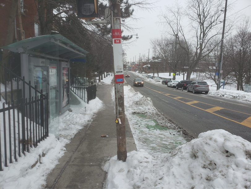 Harbord St bike lane one week after snow fall, covered in snow and ice 