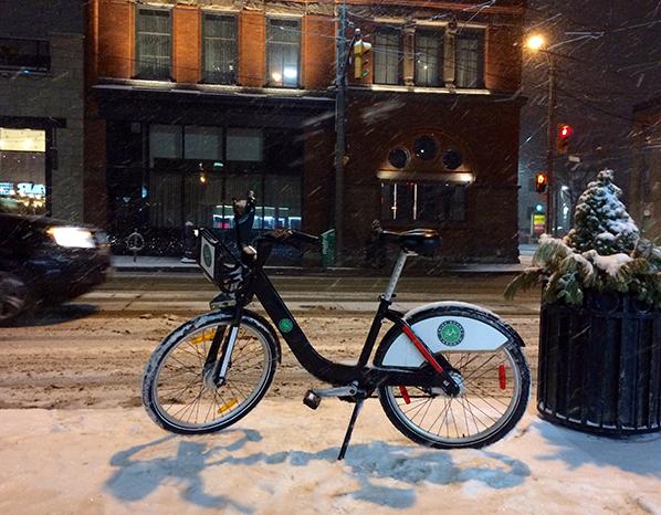 Bike Share bike parked on a snowy evening