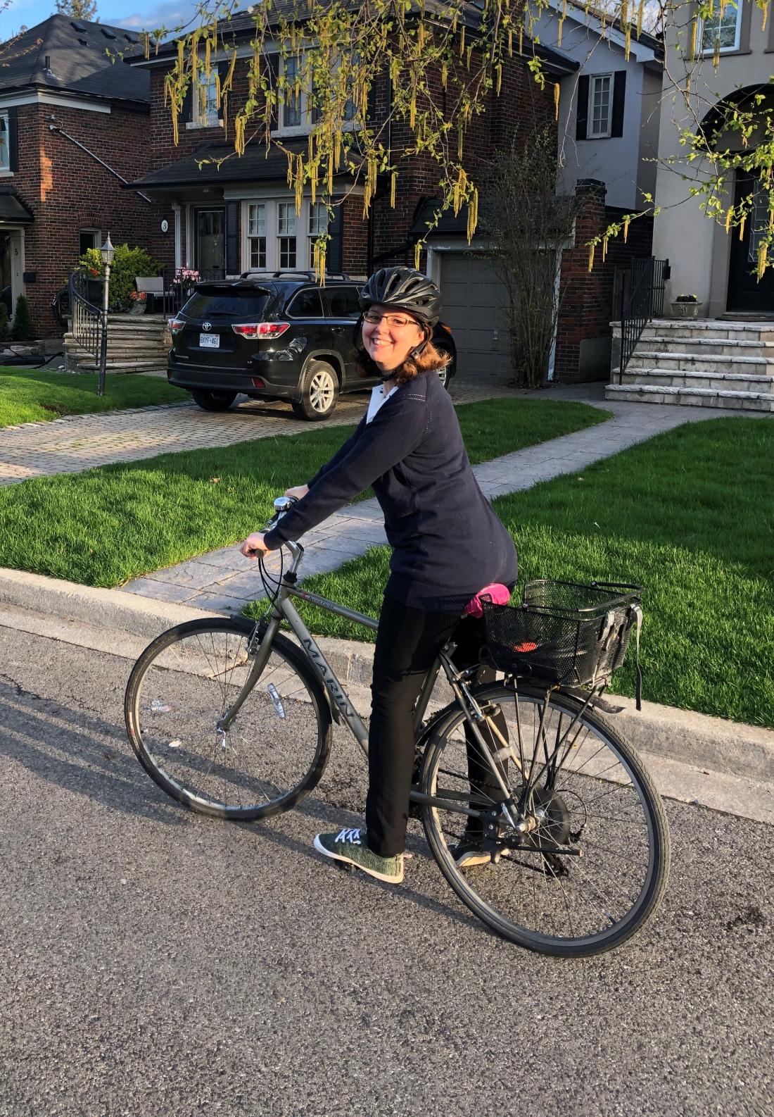 Woman on a bike in a residential neighbourhood