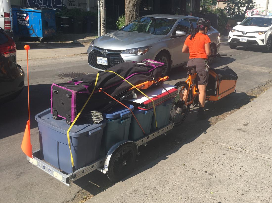 Cargo bike and trailer loaded up with several plastic crates