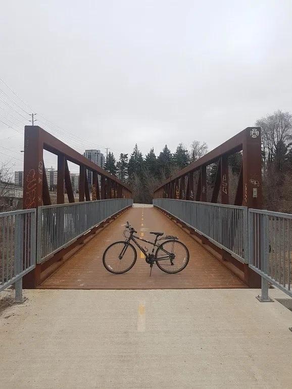 A bicycle is pictured in front of a bridge