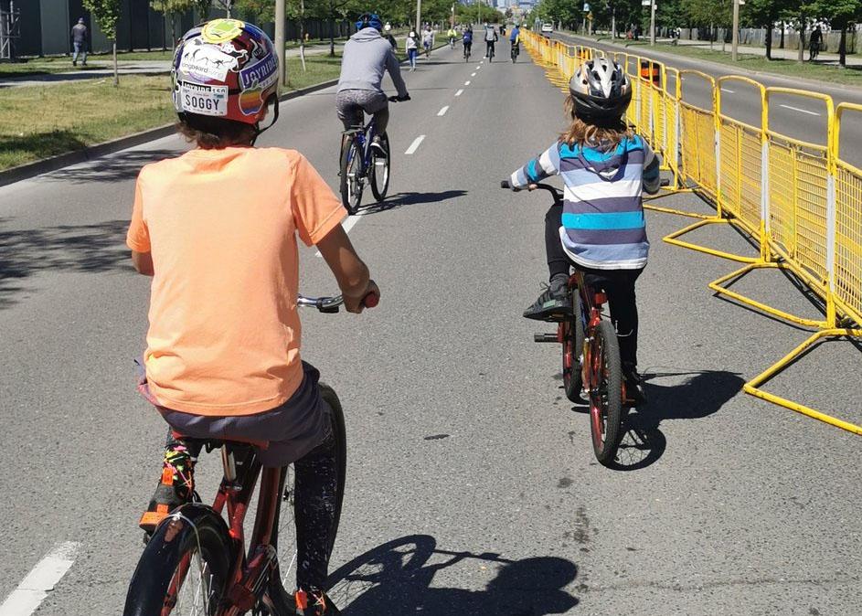 Family rides bikes on a closed roadway