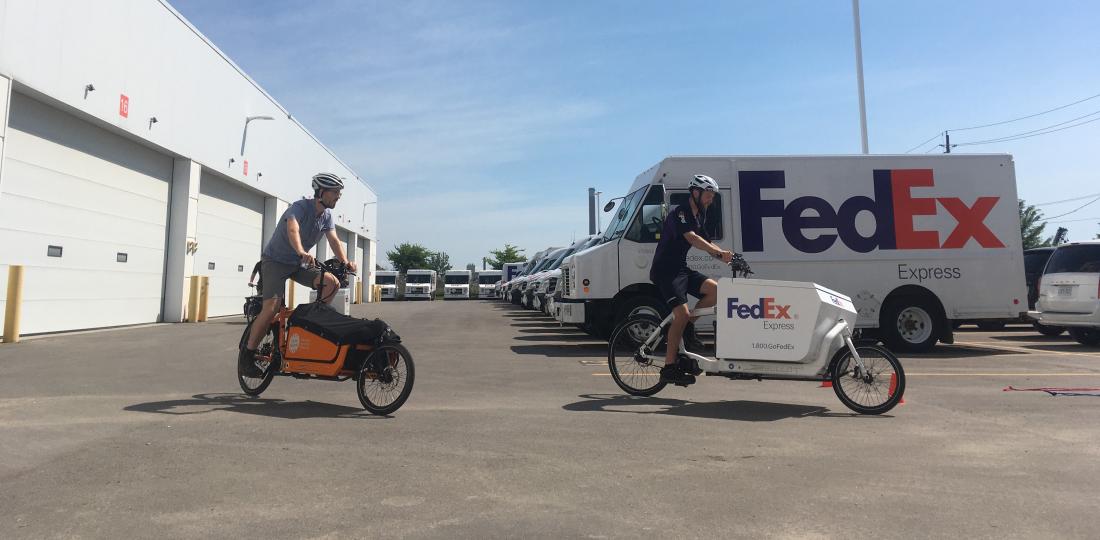 Cycle Toronto and FedEx ride cargo bikes in a van filled parking lot