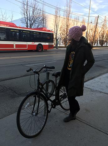 Theresa with her bike locked to a ring and post