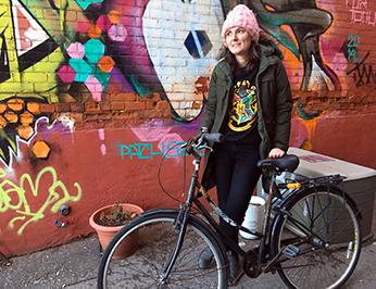 Theresa on her bike outside work