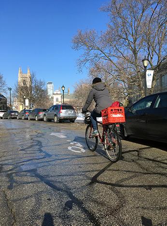 Léa riding her bike on King's College Circle at U of T