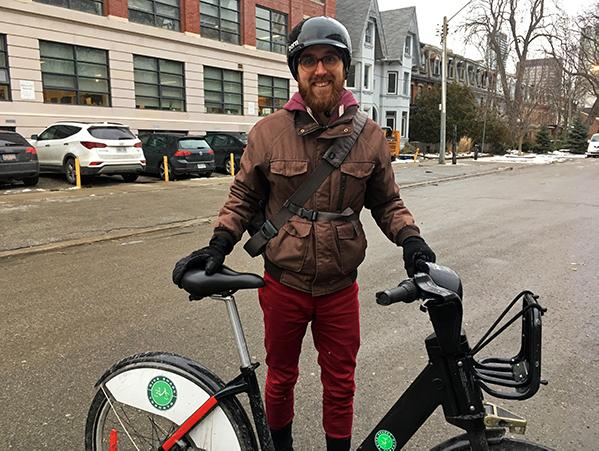 Jay posing with a Bike Share bike