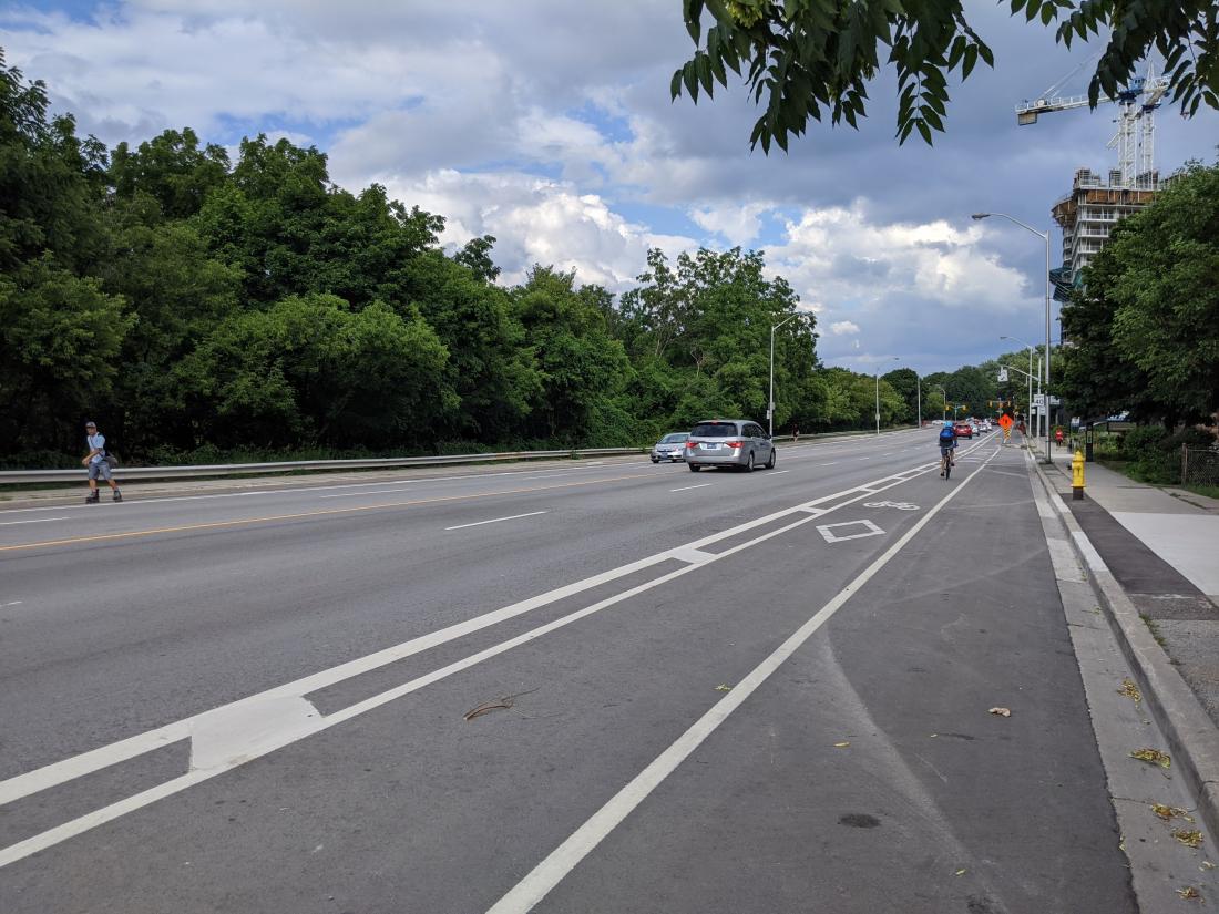 A painted bike lane has parking on the right and driving on the left.