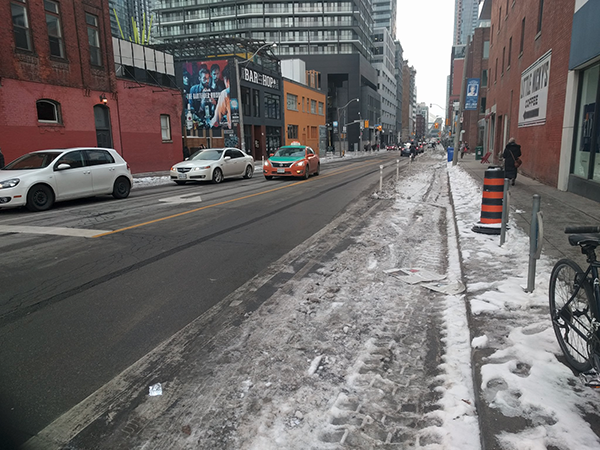 Peter St cycle track covered in snow