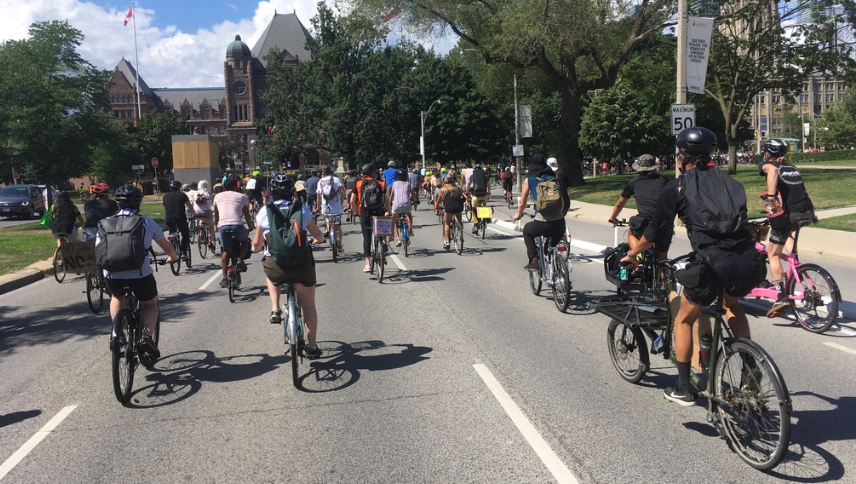 Many people ride bikes beside Queen's Park.