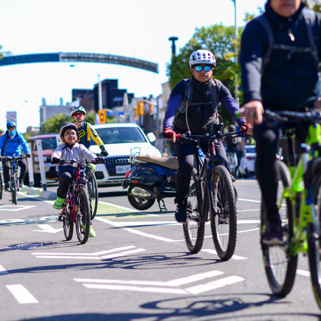 People ride bikes in a bike lane