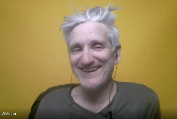 Smiling man with grey hair on a yellow background