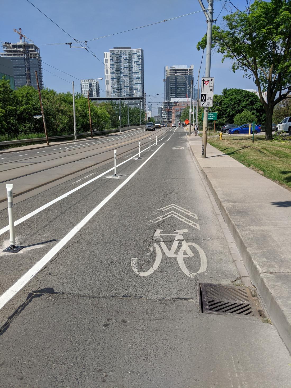 An image looking westbound of the Dundas Street East ActiveTO installation at the Don Valley Parkway on-ramp from June 2020.