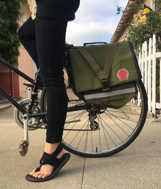 Person on a bike with a neutral tone pannier